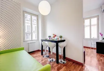 a living room with a table and two stools at Imperia Suite in Rome