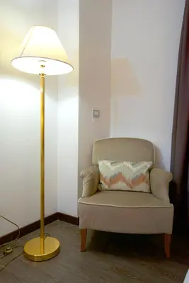 a lamp sitting next to a chair next to a lampost at St. Peter' Six Rooms & Suites in Rome