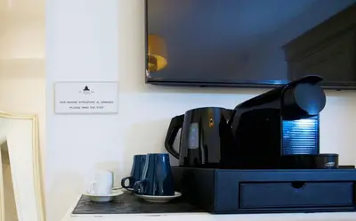 a kitchen counter with a coffee maker on a counter top at St. Peter' Six Rooms & Suites in Rome