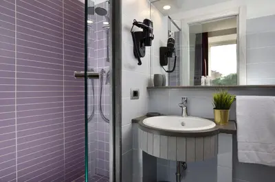 a bathroom with a sink and a shower at Colosseo Panorama by GHOR in Rome