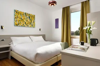 a hotel room with a bed and a window at Colosseo Panorama by GHOR in Rome