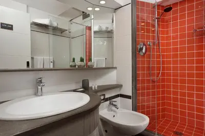 a bathroom with a sink and a toilet and a shower at Colosseo Panorama by GHOR in Rome