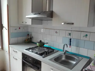 a kitchen with a sink and a pot on the stove at Liudan&rooms Affittacamere in Rome