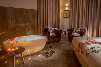 a hotel room with a bath tub and a bed at GCF Luxury Suites, Guest house in Rome