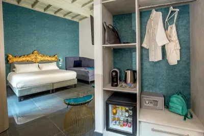 a bedroom with a bed and a room with a refrigerator at GCF Luxury Suites, Guest house in Rome