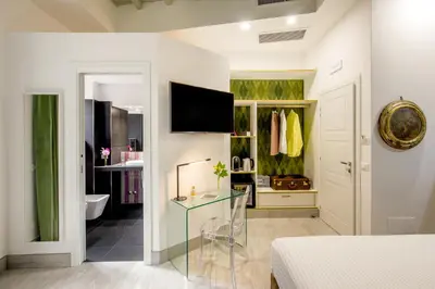 a bedroom with a glass table in a room at GCF Luxury Suites, Guest house in Rome