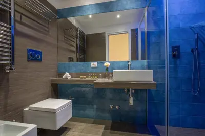 a bathroom with a toilet and a sink and a shower at GCF Luxury Suites, Guest house in Rome