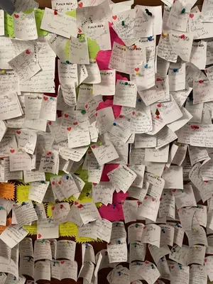a wall filled with lots of sticky notes at Meraviglia in Rome
