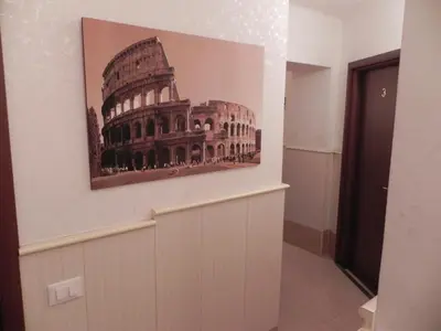 a picture of the coliseum on a wall in a room at Meraviglia in Rome