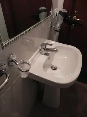 a white sink in a bathroom with a mirror at Meraviglia in Rome