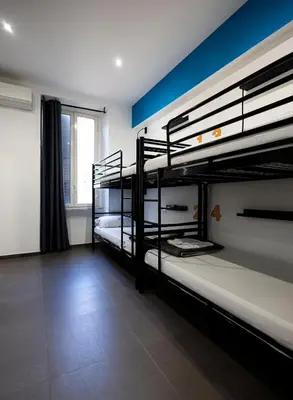a room with three bunk beds with a window at Melting Pot Rome in Rome