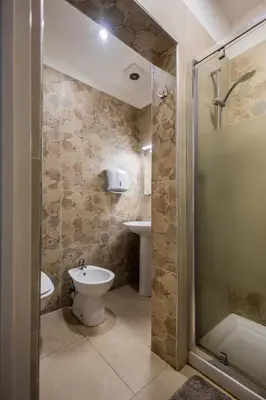 a bathroom with a toilet and a sink and a shower at Melting Pot Rome in Rome