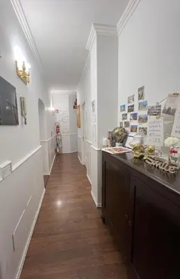 a hallway of a room with white walls and wooden floors at Suitedream Vatican in Rome