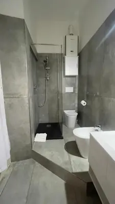 a bathroom with a shower and a toilet and a sink at Suitedream Vatican in Rome