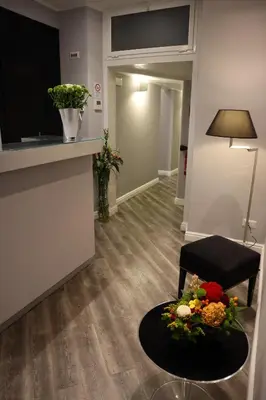 a living room with a table with flowers on it at MILLINA SUITES IN NAVONA in Rome