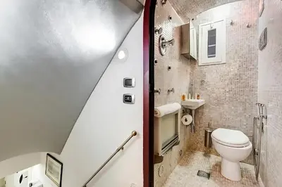 a small bathroom with a toilet and a sink at Cherì Navona in Rome