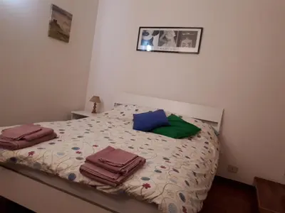 a bedroom with a bed with towels on it at Marina in Rome