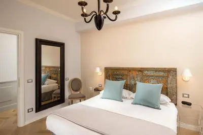 a bedroom with a large bed and a mirror at Borgo Pio Charme in Rome