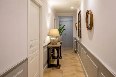 a hallway with a table with a lamp on it at Borgo Pio Charme in Rome