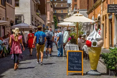 a group of people walking down a street at Borgo Pio Charme in Rome