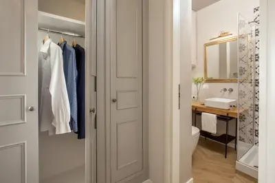 a bathroom with a toilet and a sink and a mirror at Borgo Pio Charme in Rome