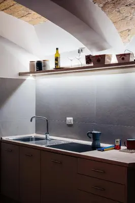 a kitchen with a sink and a counter top at Restart Accommodations Rosa in Rome