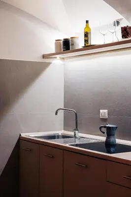 a kitchen with a sink and a counter top at Restart Accommodations Rosa in Rome