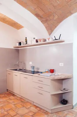 a kitchen with white cabinets and a sink at Restart Accommodations Rosa in Rome
