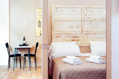 a bedroom with a bed and a table with towels on it at Restart Accommodations Rosa in Rome