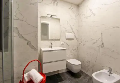 a white bathroom with a sink and a toilet at Vatican Loft - Rooms & Apartments in Rome