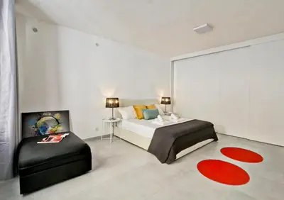a bedroom with a bed and a chair at Vatican Loft - Rooms & Apartments in Rome
