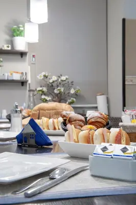 a table with plates of hot dogs and sandwiches at Bed & Breakfast Armonie Romane in Rome