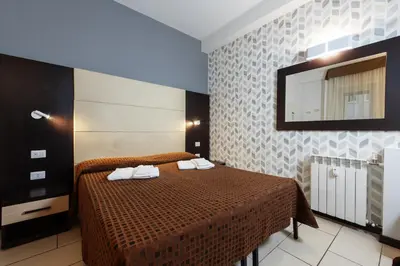 a bedroom with a bed with a mirror on the wall at Bed & Breakfast Armonie Romane in Rome