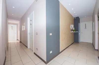 a hallway with white and blue walls and tile floors at Bed & Breakfast Armonie Romane in Rome