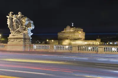 a building with a statue in front of a street at Bed & Breakfast Armonie Romane in Rome