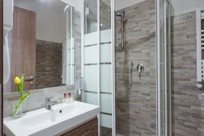 a bathroom with a sink and a shower at Suite Horti Sallustiani in Rome