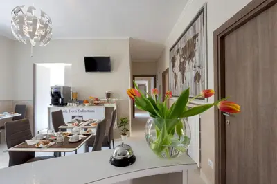 a living room with a vase of flowers on a table at Suite Horti Sallustiani in Rome