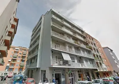 a tall building with cars parked in front of it at La Canterina al Vaticano in Rome