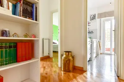 a room with a book shelf with books at La Canterina al Vaticano in Rome