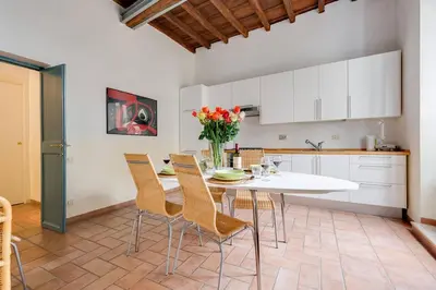 a kitchen with a white table and chairs at Domus Florea in Rome