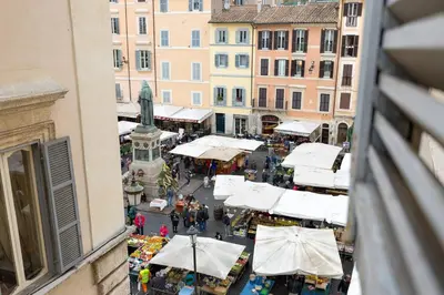 an aerial view of a market with white umbrellas at Domus Florea in Rome