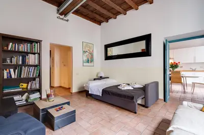 a bedroom with a bed and a living room at Domus Florea in Rome