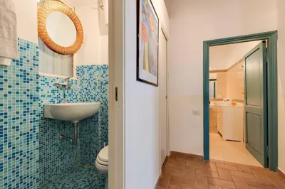a bathroom with a sink and a toilet and a mirror at Domus Florea in Rome