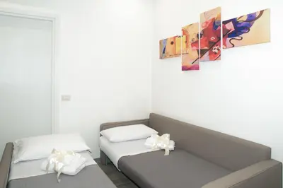 a room with two beds and a painting on the wall at The Dream Of Colosseum in Rome