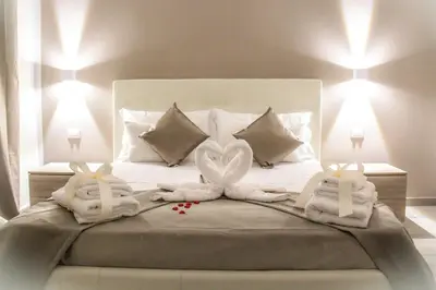 a bed with two towels in the shape of hearts at The Dream Of Colosseum in Rome