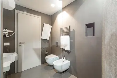 a bathroom with a toilet and a sink at A World Aparts - Barberini Boutique Hotel in Rome