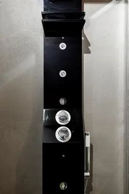 a black stand with three silver knobs on it at A World Aparts - Barberini Boutique Hotel in Rome