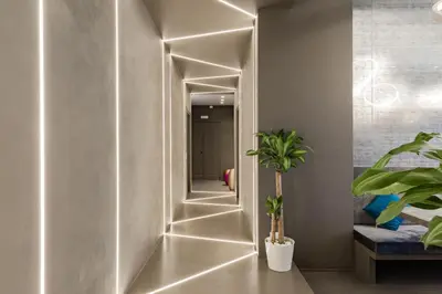a hallway with lights on the wall at A World Aparts - Barberini Boutique Hotel in Rome