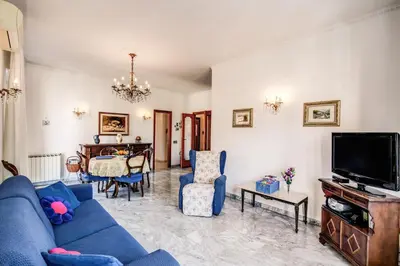a living room with a blue couch and a tv at BlueClassicHome in Rome