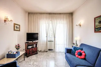 a living room with a blue couch and a tv at BlueClassicHome in Rome